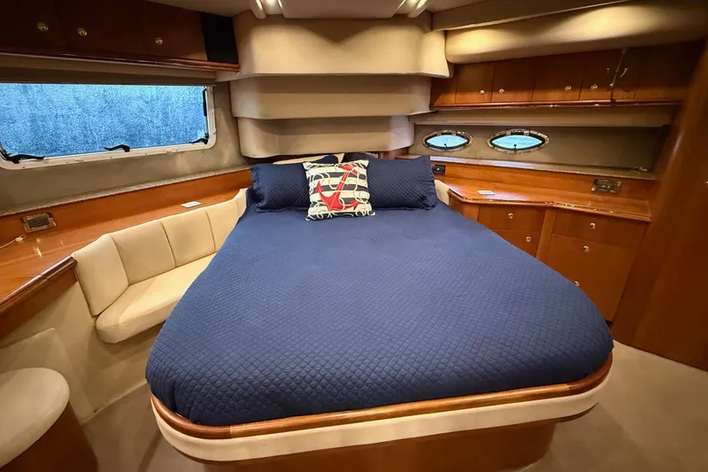 Slide: The Image of Luxurious cabin interior of 2001 Cruisers 4450 ACMY yacht with blue bedding. - 16