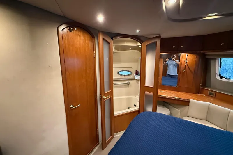 Slide: The Image of Luxurious 2001 Cruisers 4450 ACMY yacht interior with wood finishes and cozy seating area. - 17
