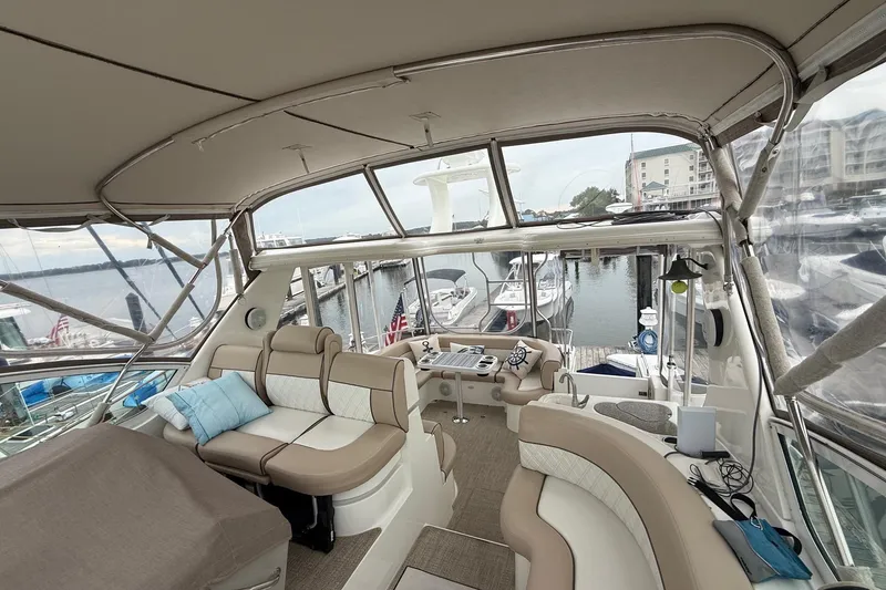 Slide: The Image of Luxurious 2001 Cruisers 4450 ACMY yacht interior with plush seating and marina view. - 7