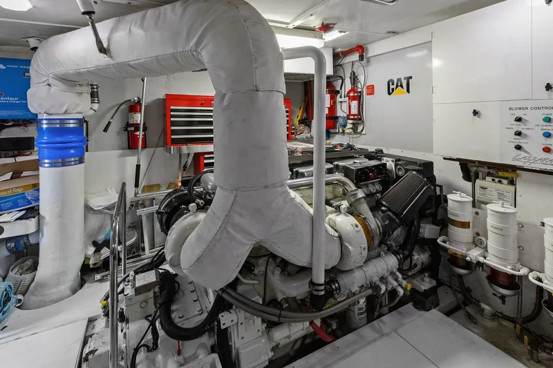 Slide: The Image of Engine room of a Lazzara yacht featuring CAT machinery and various equipment. - 101