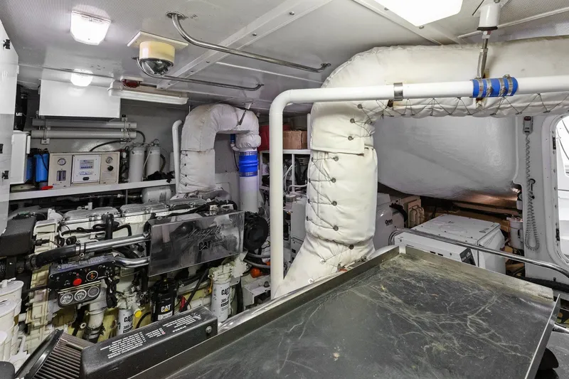 Slide: The Image of Engine room of a Lazzara yacht featuring CAT machinery and insulated piping. - 102