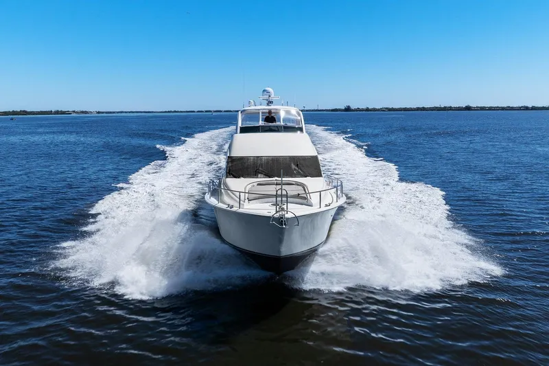 Slide: The Image of Lazzara yacht cruising on open water under clear blue sky. - 13