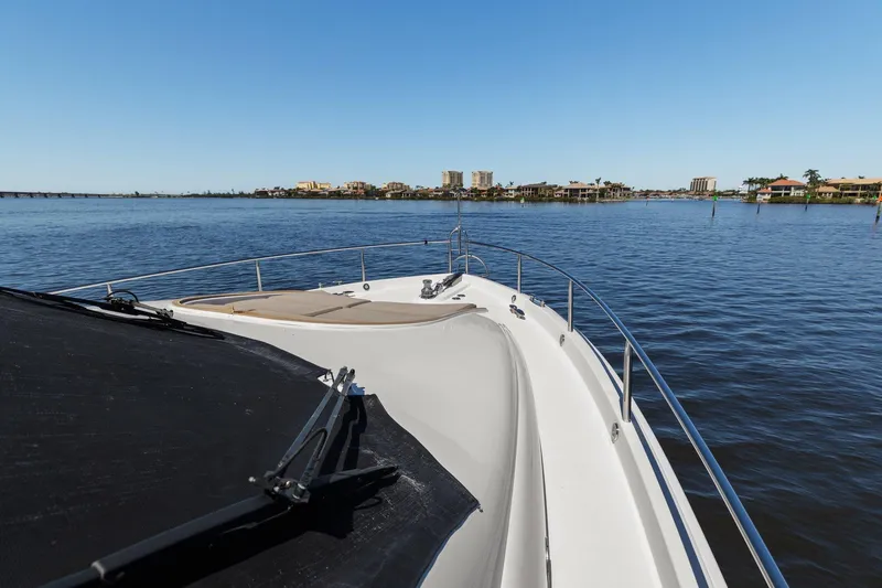Slide: The Image of Bow view of a Lazzara yacht cruising on a calm, scenic waterway. - 17