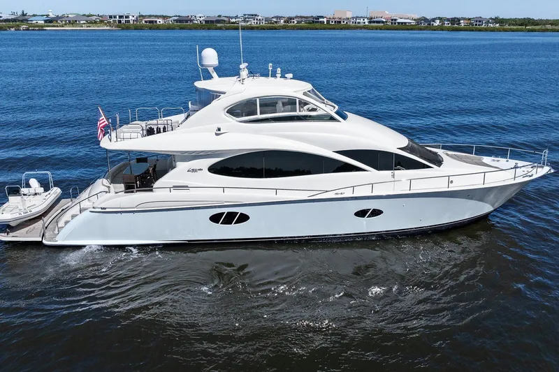 Slide: The Image of 2005 Lazzara 68 Flybridge yacht on calm waters. - 2