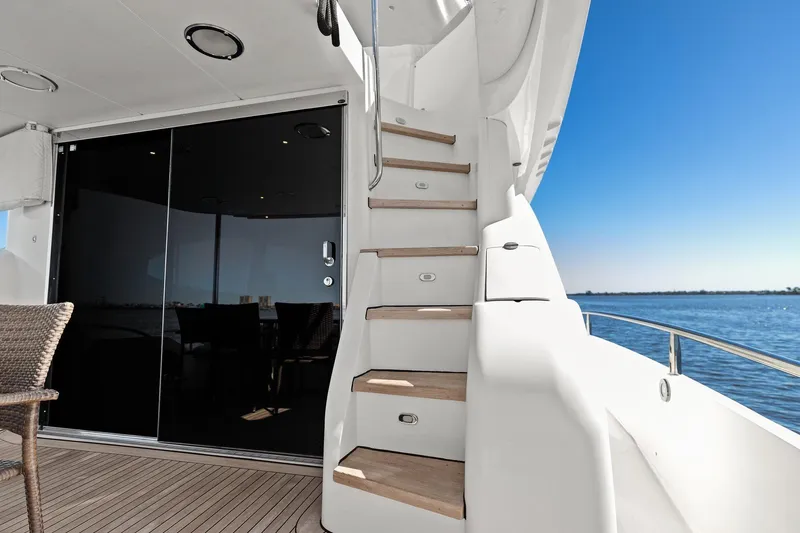 Slide: The Image of Luxury yacht deck with wooden stairs, glass doors, and ocean view. Lazzara make. - 24