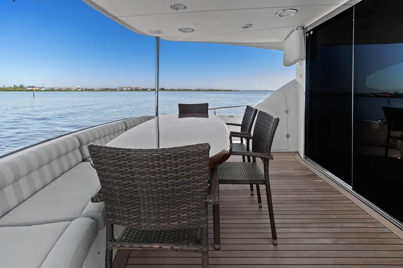 Slide: The Image of Outdoor seating area on a Lazzara yacht with ocean view and wicker chairs. - 26