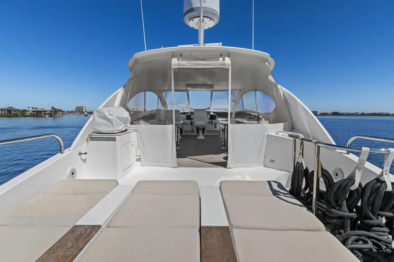 Slide: The Image of Luxury Lazzara yacht deck with sun loungers, overlooking calm blue waters. - 29