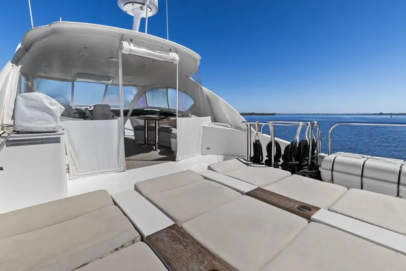 Slide: The Image of Luxury Lazzara yacht deck with seating, overlooking serene blue waters. - 30