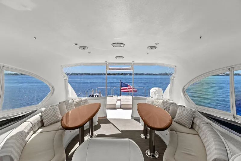 Slide: The Image of Luxurious Lazzara yacht interior with elegant seating, wooden tables, and ocean view. - 33