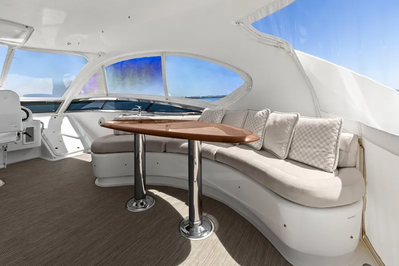 Slide: The Image of Luxurious Lazzara yacht interior with curved seating, elegant table, and panoramic windows. - 34