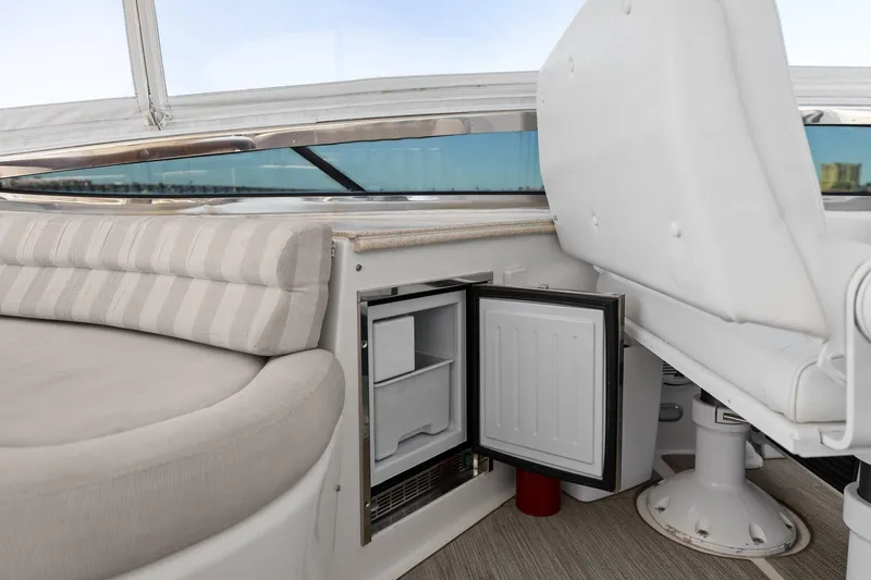 Slide: The Image of Luxury Lazzara yacht interior with open mini fridge and cushioned seating area. - 36