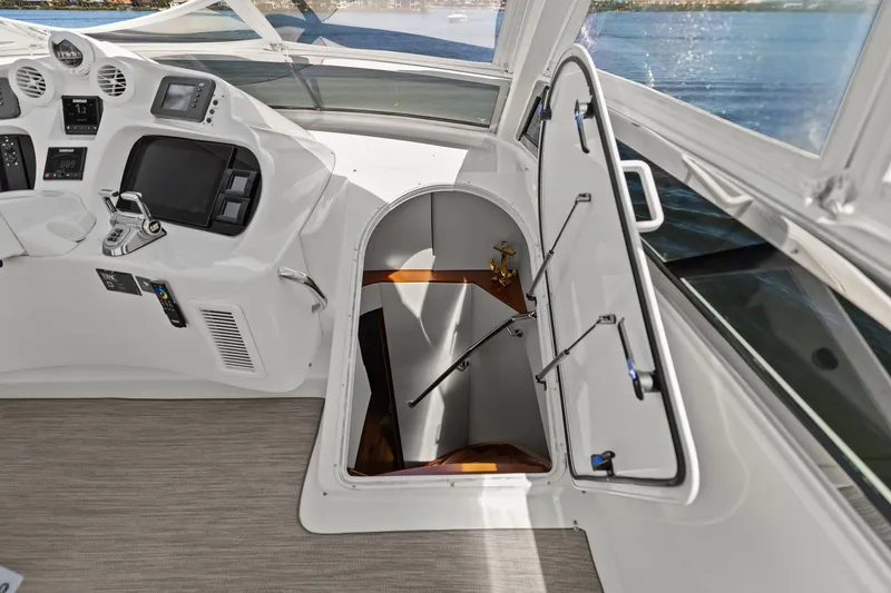 Slide: The Image of Lazzara yacht interior with helm controls and open hatch leading below deck. - 41