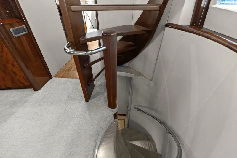 Slide: The Image of Spiral staircase inside a Lazzara yacht with wooden and metal accents. - 48