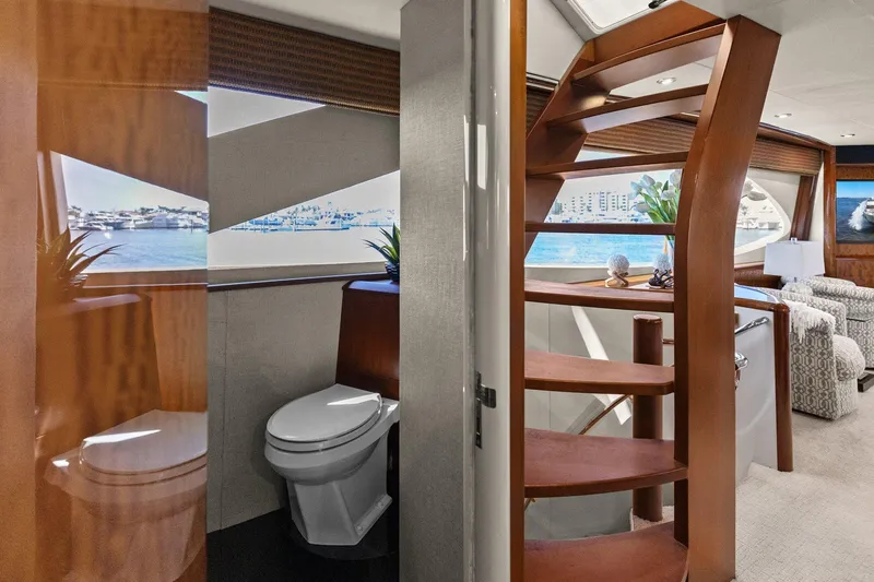 Slide: The Image of Luxurious Lazzara yacht interior with wooden staircase, modern bathroom, and scenic ocean view. - 50