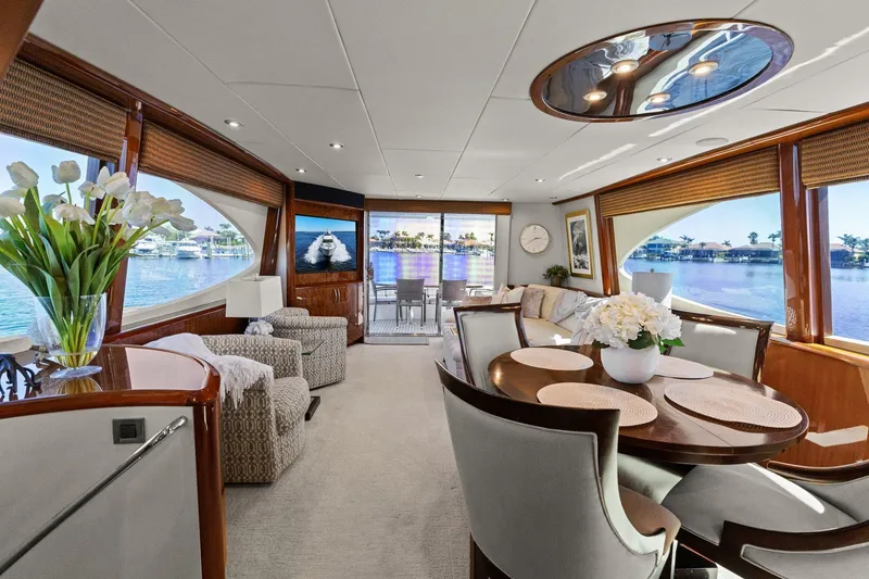 Slide: The Image of Luxurious Lazzara yacht interior with elegant dining area, plush seating, and scenic water views. - 52