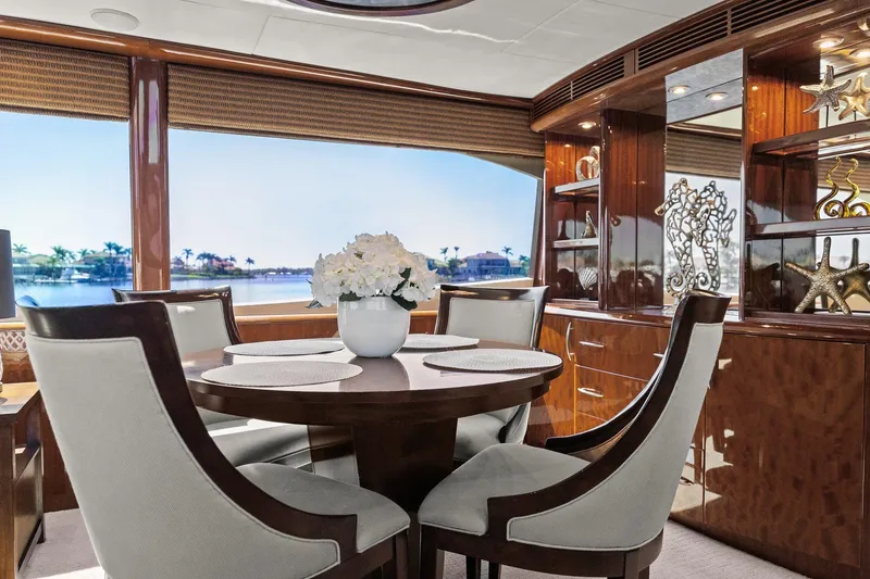 Slide: The Image of Luxurious Lazzara yacht interior with elegant dining area, wooden finishes, and scenic water view. - 53