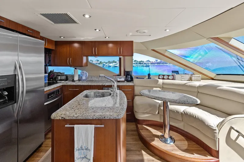Slide: The Image of Luxurious Lazzara yacht interior with modern kitchen and seating, featuring ocean view windows. - 56