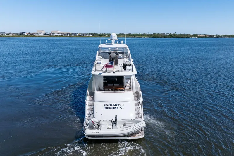 Slide: The Image of Lazzara yacht "Father's Destiny" cruising on calm blue waters under clear skies. - 6
