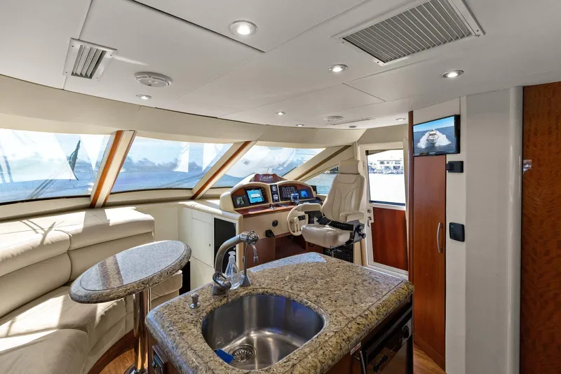 Slide: The Image of Luxurious Lazzara yacht interior with helm, granite countertop, and panoramic windows. - 60