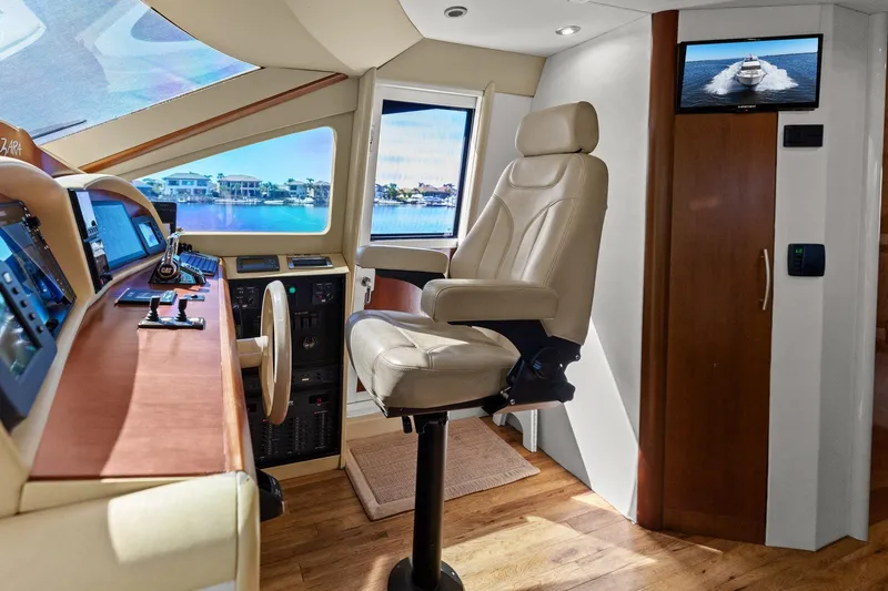 Slide: The Image of Luxurious Lazzara yacht helm with leather captain's chair and advanced navigation controls. - 62