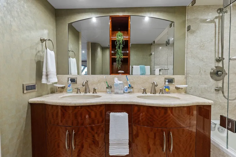 Slide: The Image of Luxurious Lazzara yacht bathroom with double sinks, elegant fixtures, and marble countertop. - 73