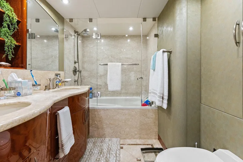 Slide: The Image of Luxurious Lazzara yacht bathroom with marble countertops, glass shower, and elegant fixtures. - 74