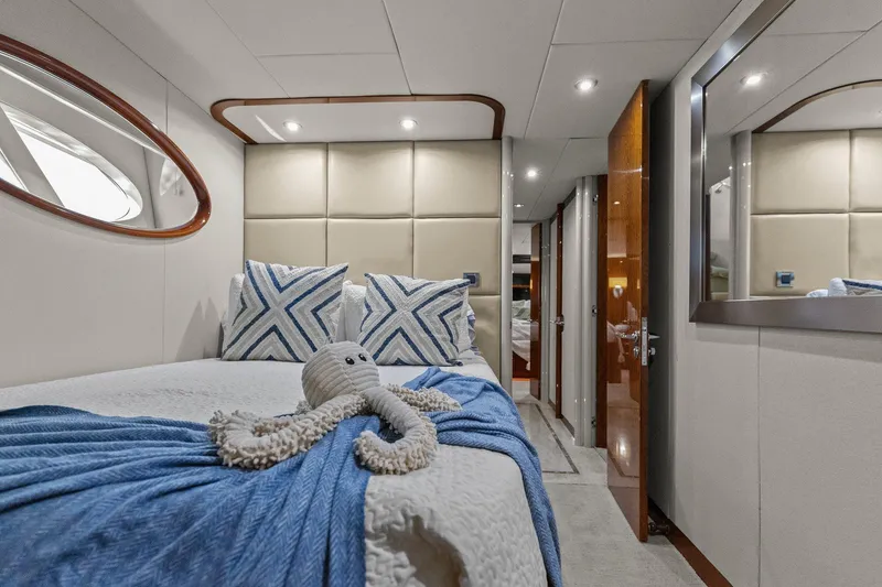 Slide: The Image of Luxurious Lazzara yacht bedroom with plush bedding, decorative pillows, and a cozy ambiance. - 76