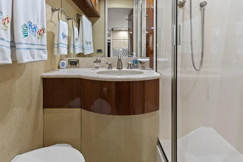 Slide: The Image of Luxurious Lazzara yacht bathroom with elegant sink, shower, and decorative towels. - 79