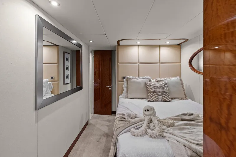Slide: The Image of Luxurious Lazzara yacht bedroom with plush bedding and elegant decor. - 80