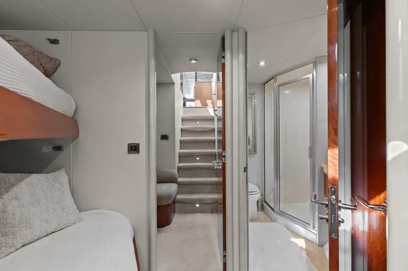 Slide: The Image of Luxurious Lazzara yacht interior with bunk beds, stairs, and modern bathroom. - 86