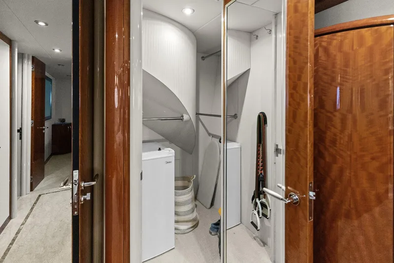Slide: The Image of Laundry room on a Lazzara yacht with ironing board and compact appliances. - 89