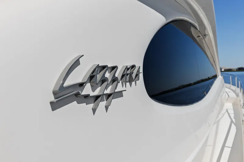 Slide: The Image of Close-up of Lazzara yacht logo on sleek white exterior with reflective window. - 93