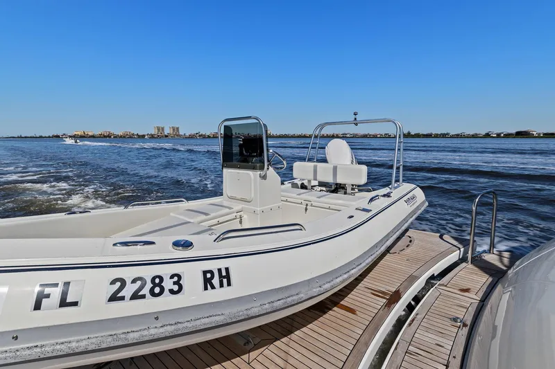 Slide: The Image of Lazzara boat on water with clear blue sky and distant cityscape. - 94
