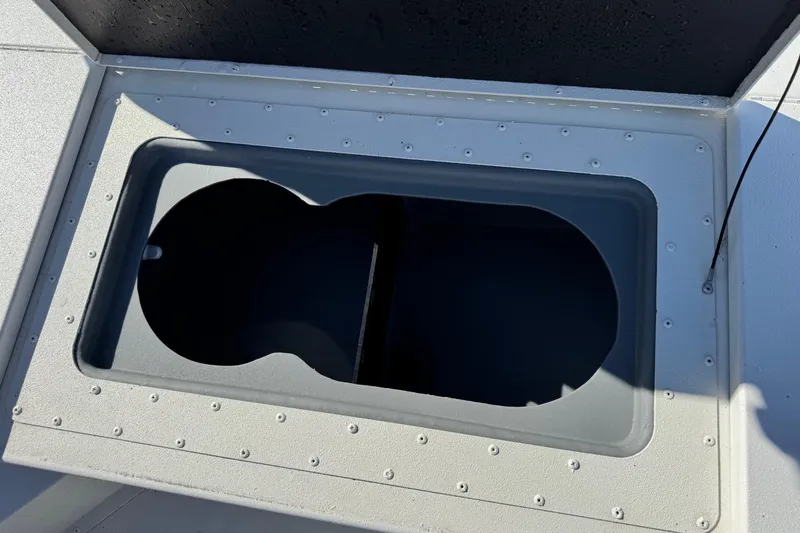 Slide: The Image of 2023 G3 Bay 17 boat compartment with open hatch, showcasing interior storage space. - 16
