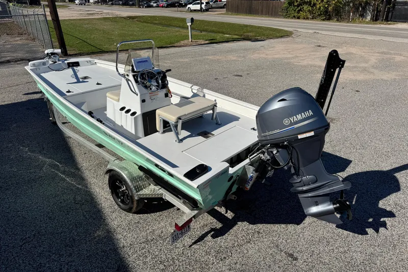 Slide: The Image of 2023 G3 Bay 17 boat with Yamaha outboard motor on a trailer. - 2