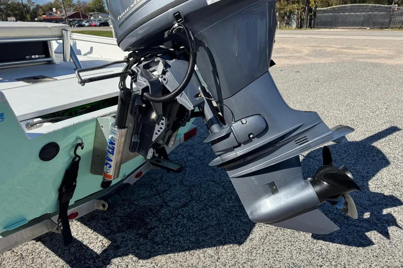 Slide: The Image of Outboard motor on a 2023 G3 Bay 17 boat, parked on asphalt. - 6