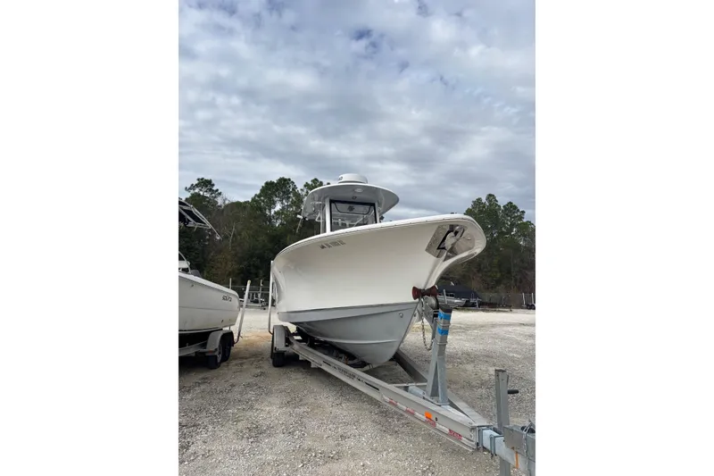 Slide: The Image of 2019 Sea Hunt Gamefish 27 Coffin Box boat on trailer, parked outdoors. - 15
