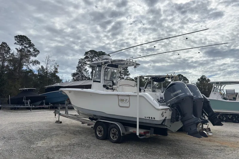 Slide: The Image of 2019 Sea Hunt Gamefish 27 Coffin Box boat on trailer, parked outdoors. - 16