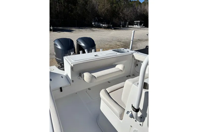 Slide: The Image of 2019 Sea Hunt Gamefish 27 Coffin Box boat interior with dual engines and seating. - 18