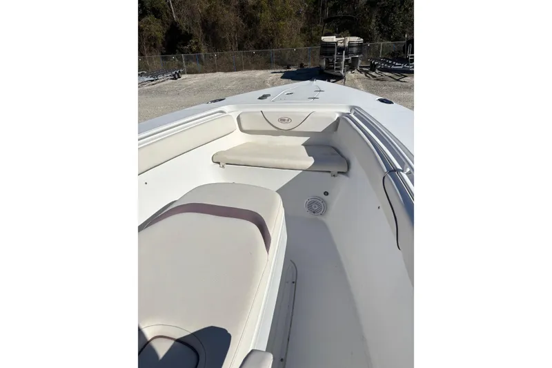 Slide: The Image of 2019 Sea Hunt Gamefish 27 Coffin Box boat interior with seating and storage. - 19