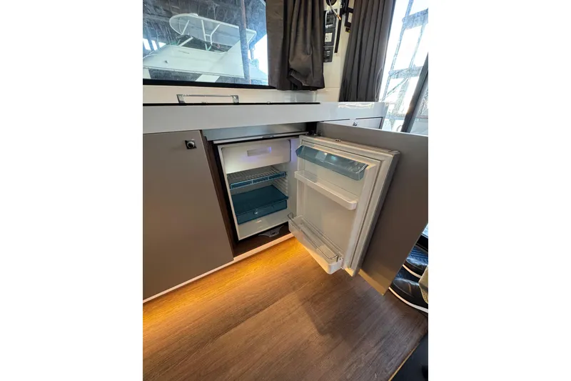 Slide: The Image of Open fridge in 2025 Beneteau Antares 11 Fly yacht interior, showcasing modern design. - 13