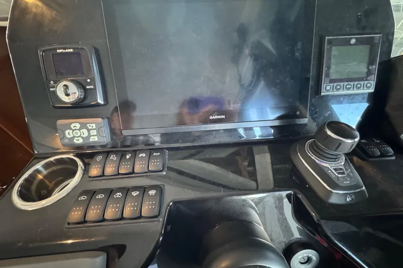 Slide: The Image of Control panel of 2025 Beneteau Antares 11 Fly with Garmin display and joystick. - 19