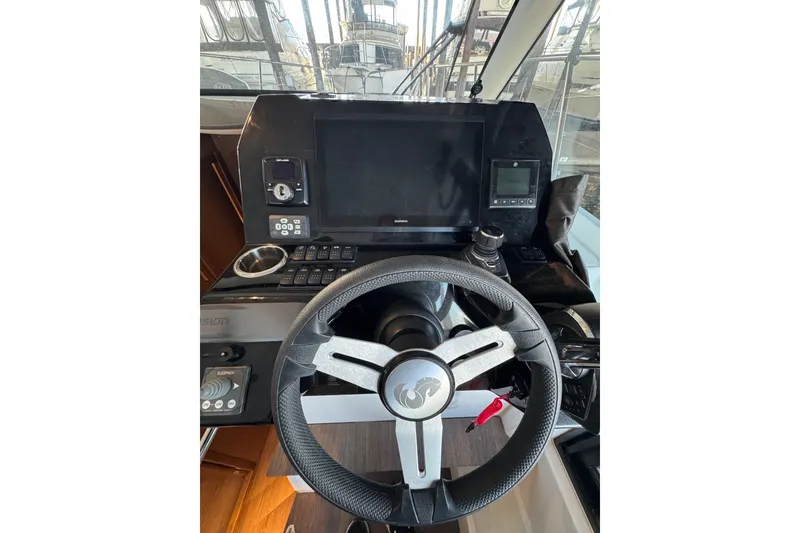 Slide: The Image of Helm of 2025 Beneteau Antares 11 Fly with modern navigation controls and steering wheel. - 21