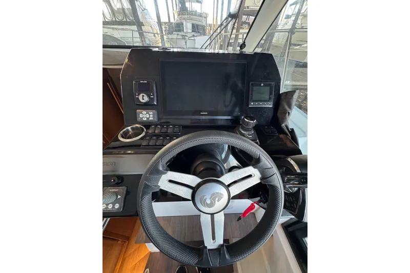 Slide: The Image of Steering console of 2025 Beneteau Antares 11 Fly with modern navigation equipment. - 22