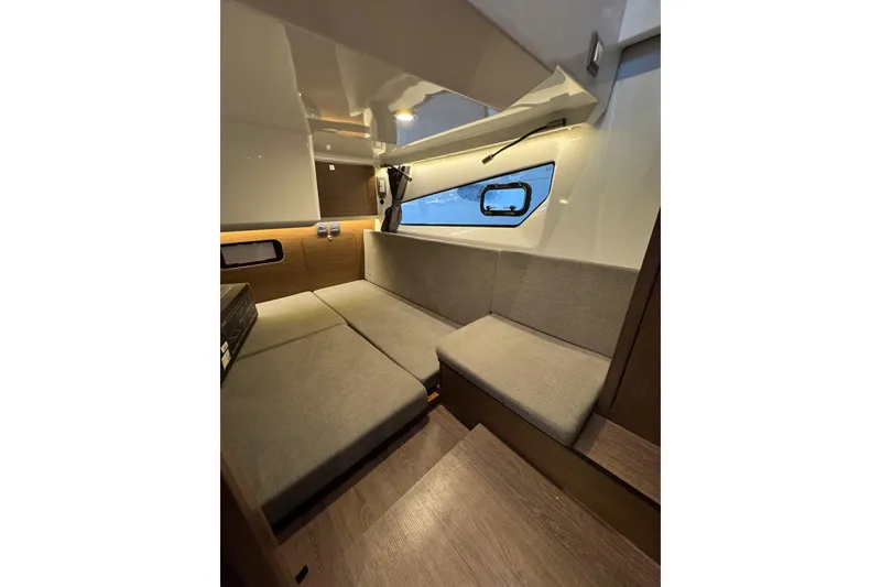 Slide: The Image of Interior of 2025 Beneteau Antares 11 Fly, featuring modern seating and window view. - 32