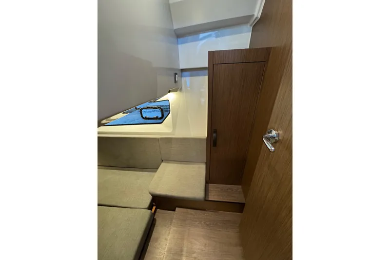 Slide: The Image of Interior of 2025 Beneteau Antares 11 Fly, featuring wooden cabinetry and seating. - 34