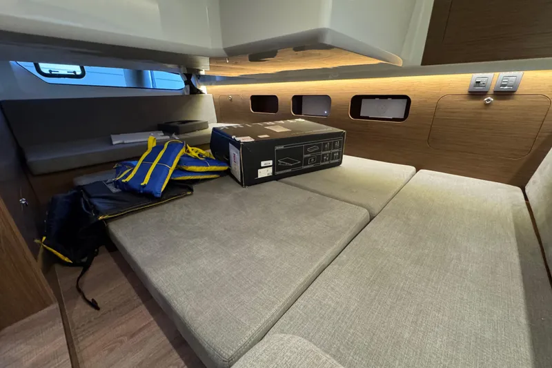Slide: The Image of 2025 Beneteau Antares 11 Fly cabin interior with modern furnishings and storage. - 35