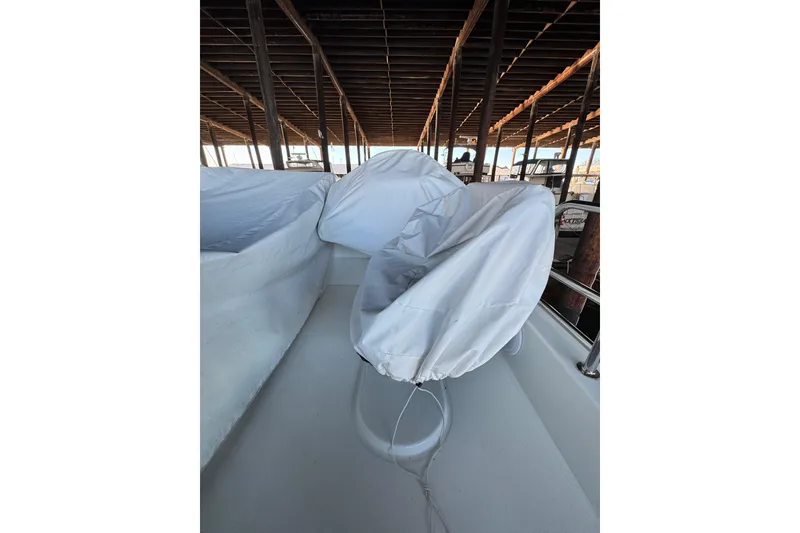 Slide: The Image of Covered seating area on 2025 Beneteau Antares 11 Fly boat under a dock. - 43