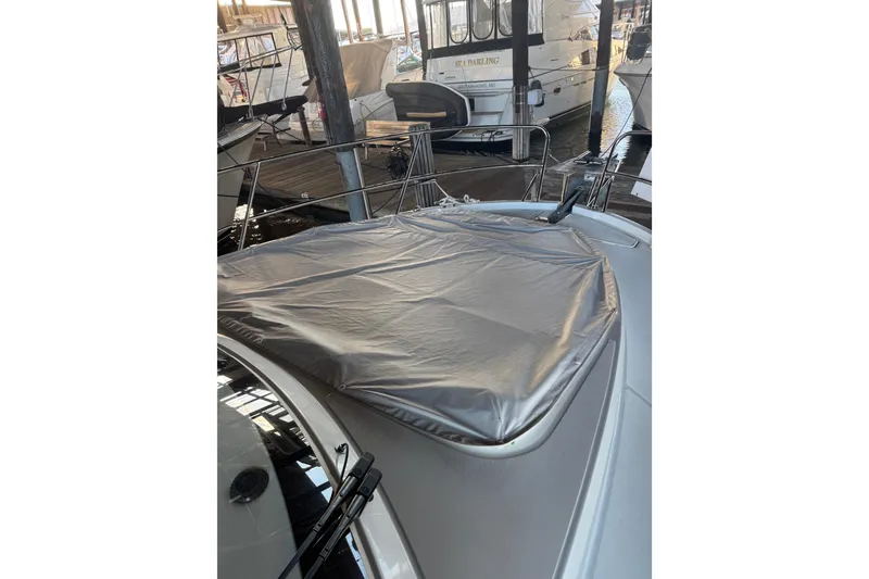 Slide: The Image of 2025 Beneteau Antares 11 Fly yacht with covered deck, docked in marina. - 46