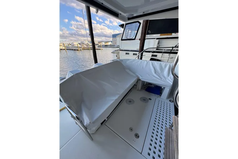 Slide: The Image of 2025 Beneteau Antares 11 Fly cockpit with covered seating, docked at marina. - 5